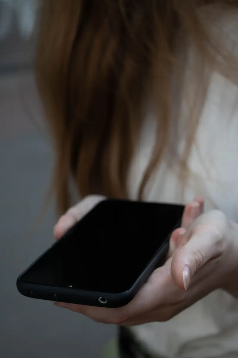 Person holding a phone with a wallet card